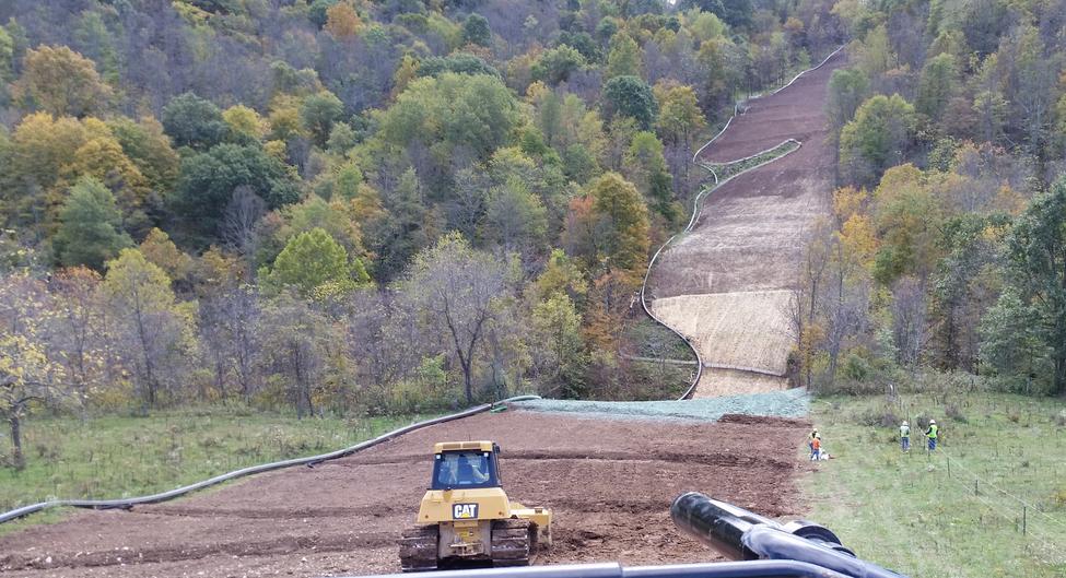 Aerial view of erosion control construction site with bulldozer and pipeline